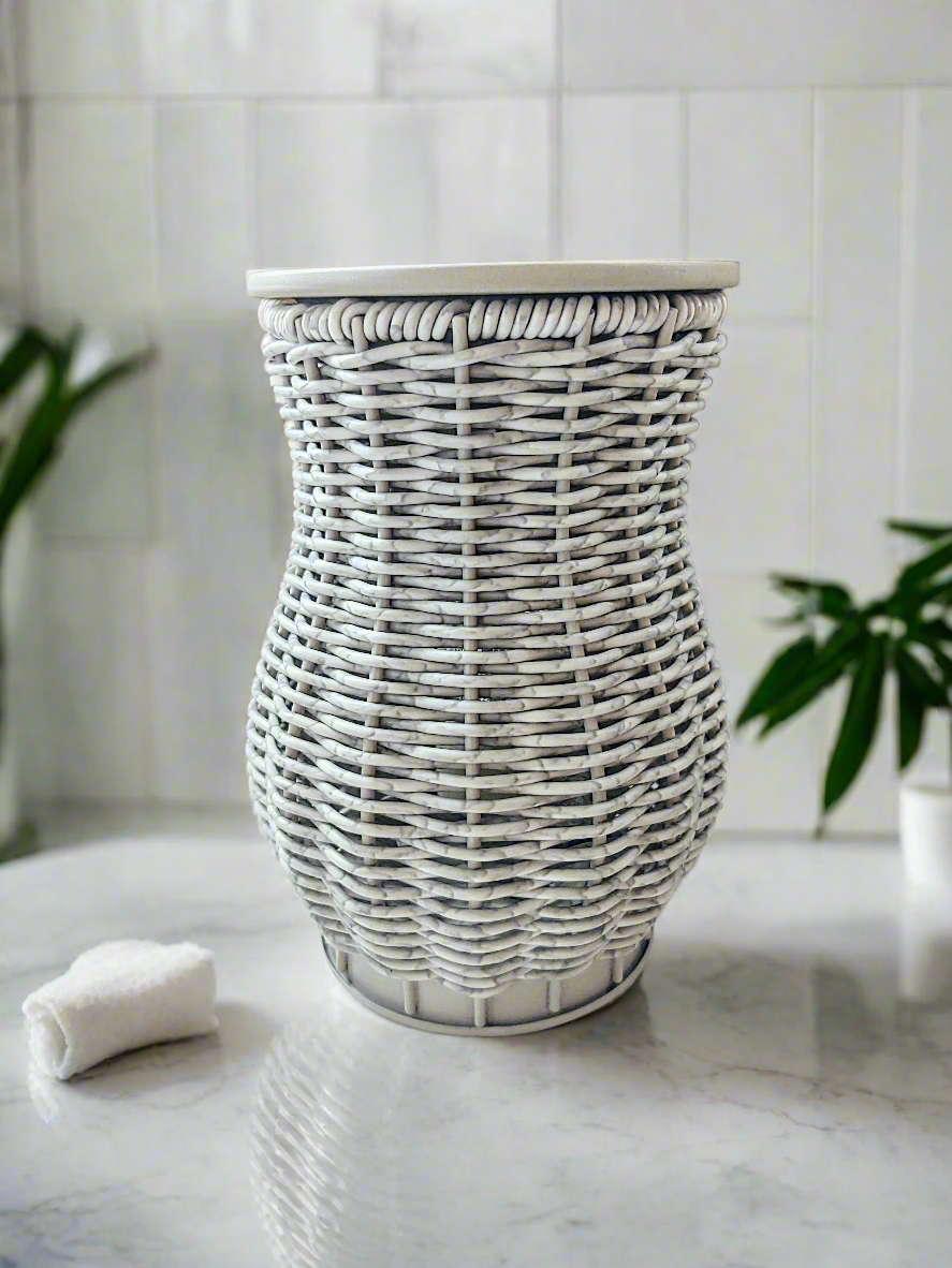 A grey washed wicker wax warmer. Electric plug in.