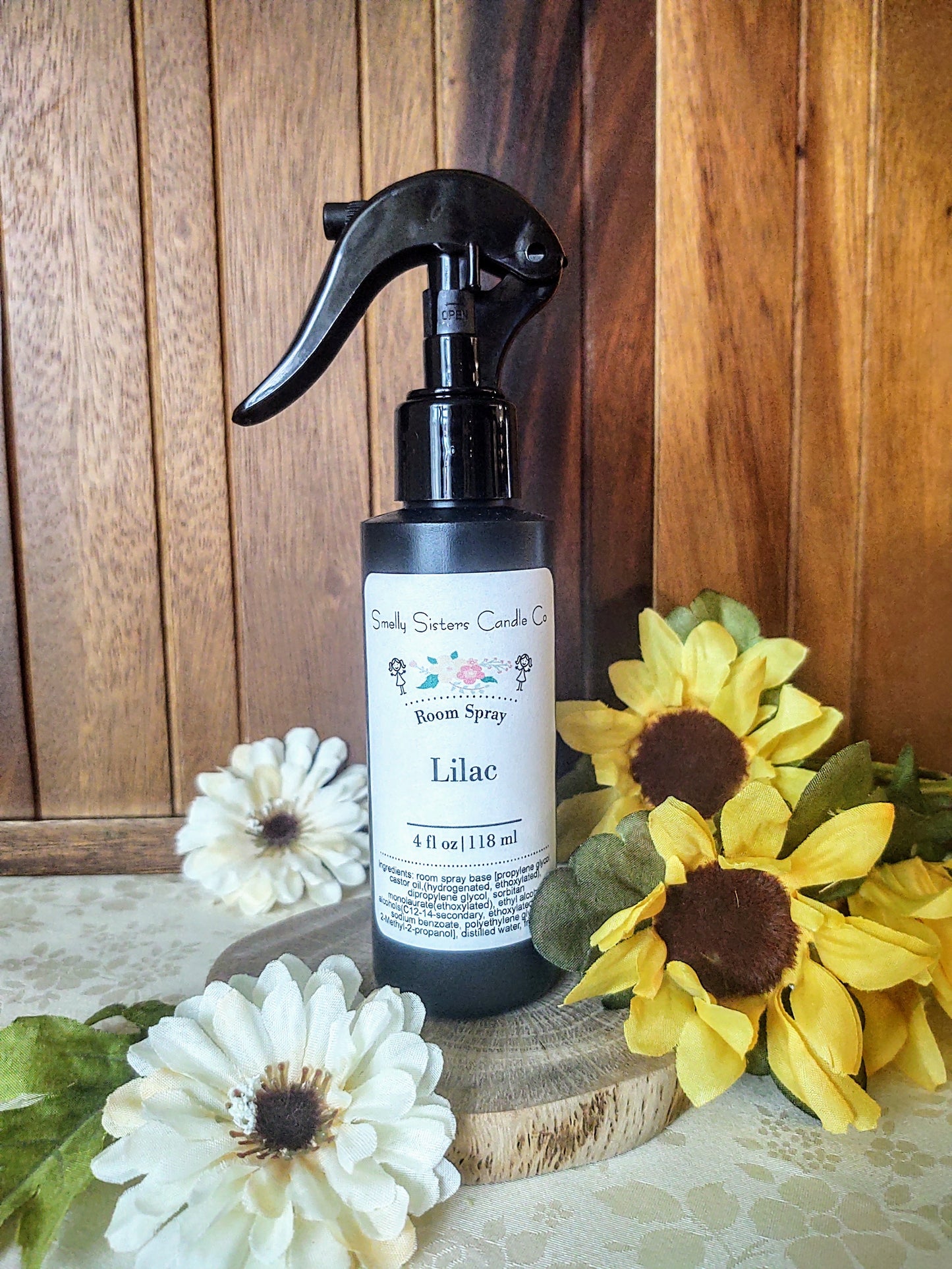 A black plastic bottle with a fine mist spray nozzle. Lilac scented room spray. Phthalate free fragrances.