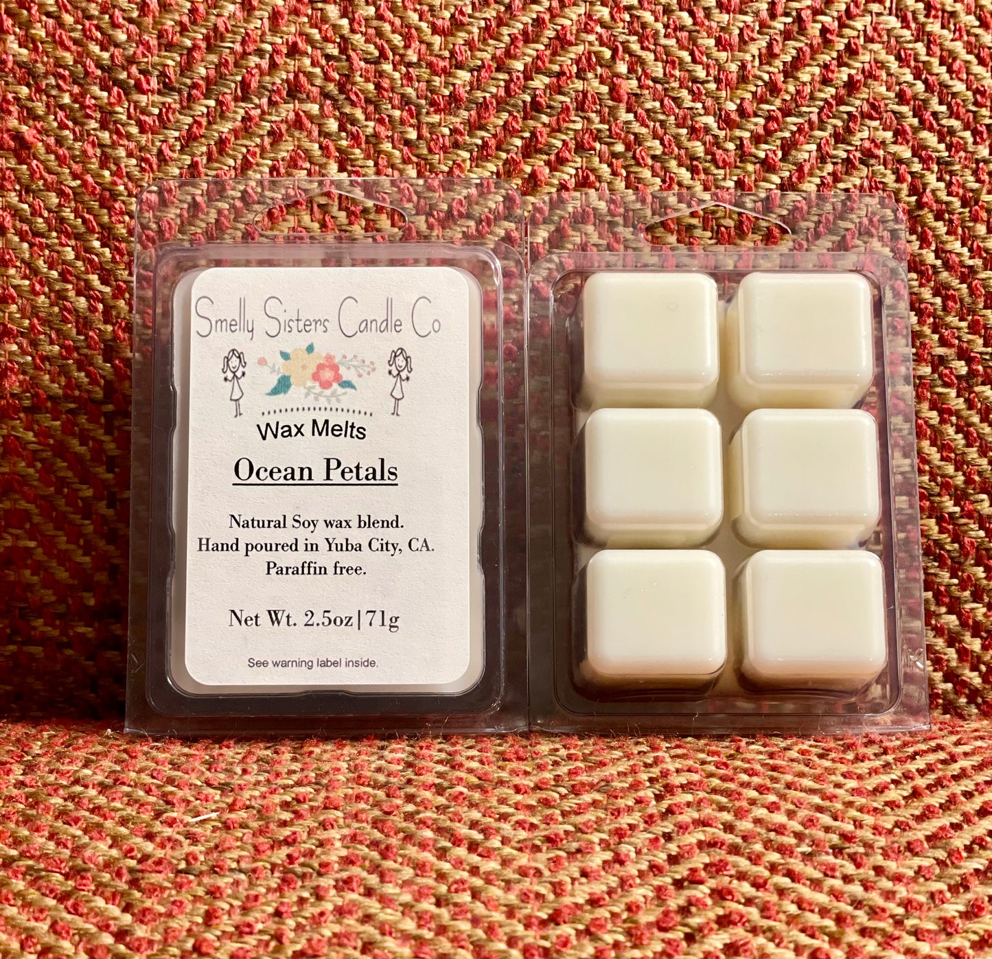 A package of Ocean Petals soy and beeswax wax melts, showing six white cubes of wax melt in a clear plastic clamshell container, with a label that includes the product name and details.