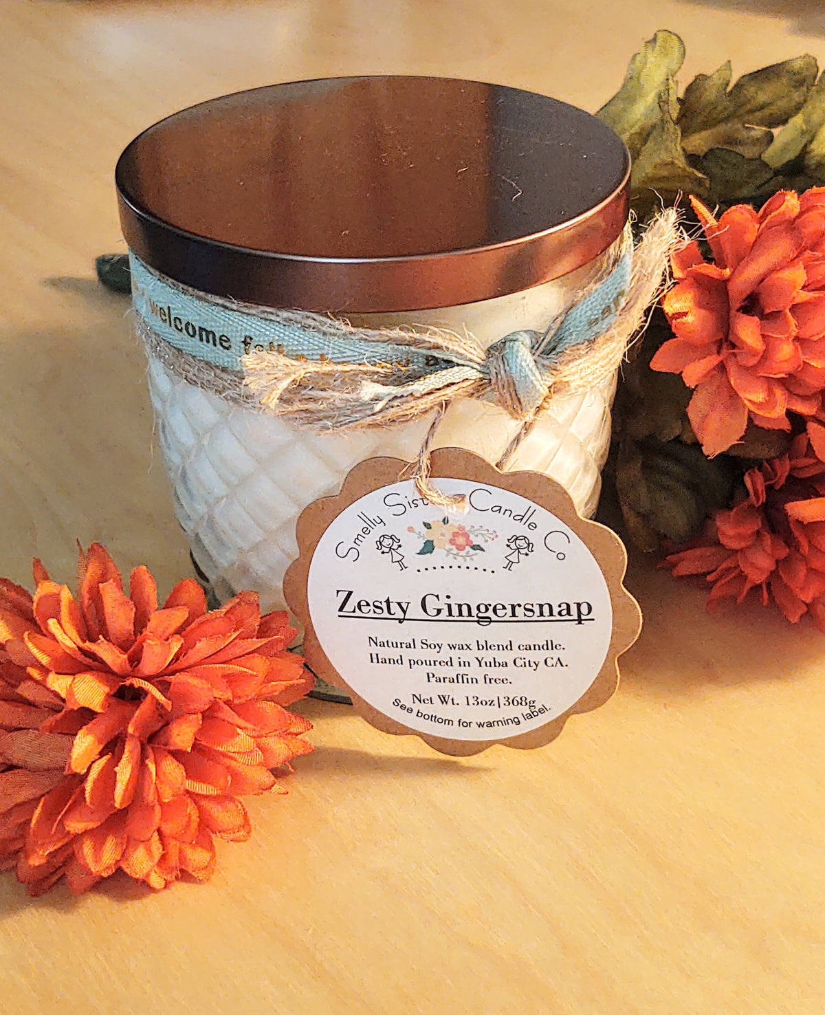 A decorative glass 8oz natural soy wax scented candle with a bronze metal lid. Double wicked with cleaner burning cotton wicks. Paraffin free, phthalate free fragrance infused with essential oils, gingersnap holiday fall scent.