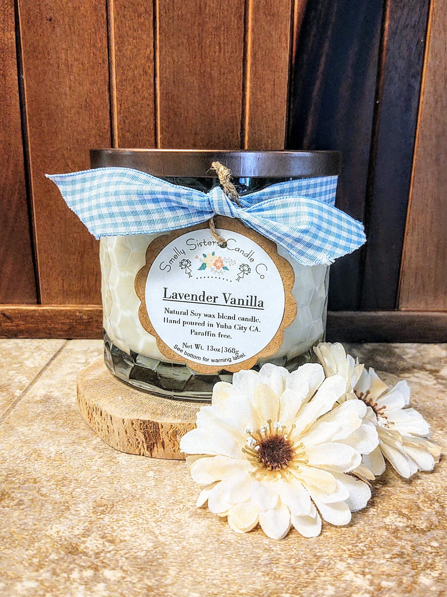 Natural soy wax Lavender and vanilla scented candle in a luxury glass jar with a decorative ribbon around it.