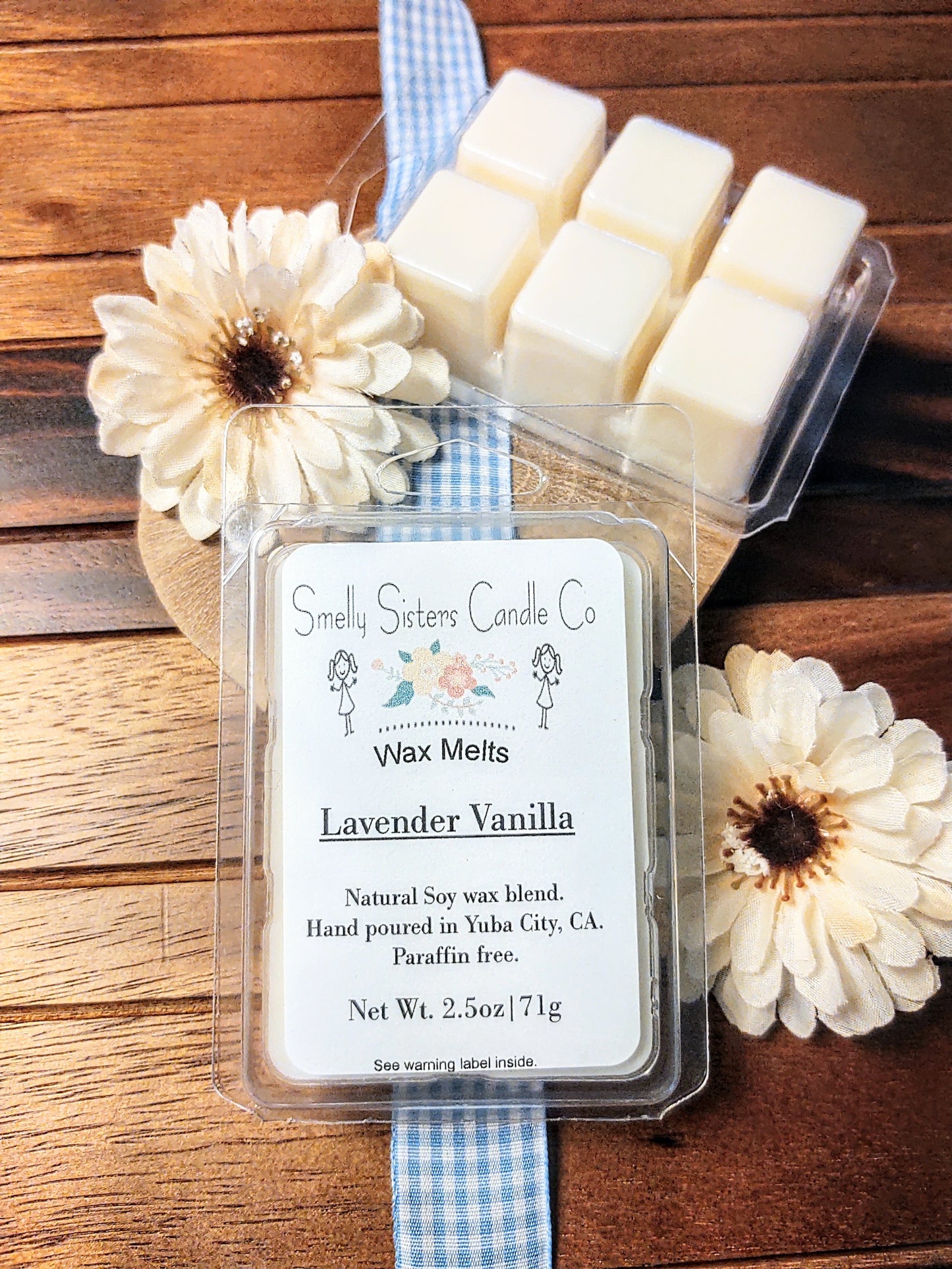 Pack of Lavender Vanilla wax melts on a wooden surface with flowers. Beeswax and soy wax. Cleaner wax melts. Natural.