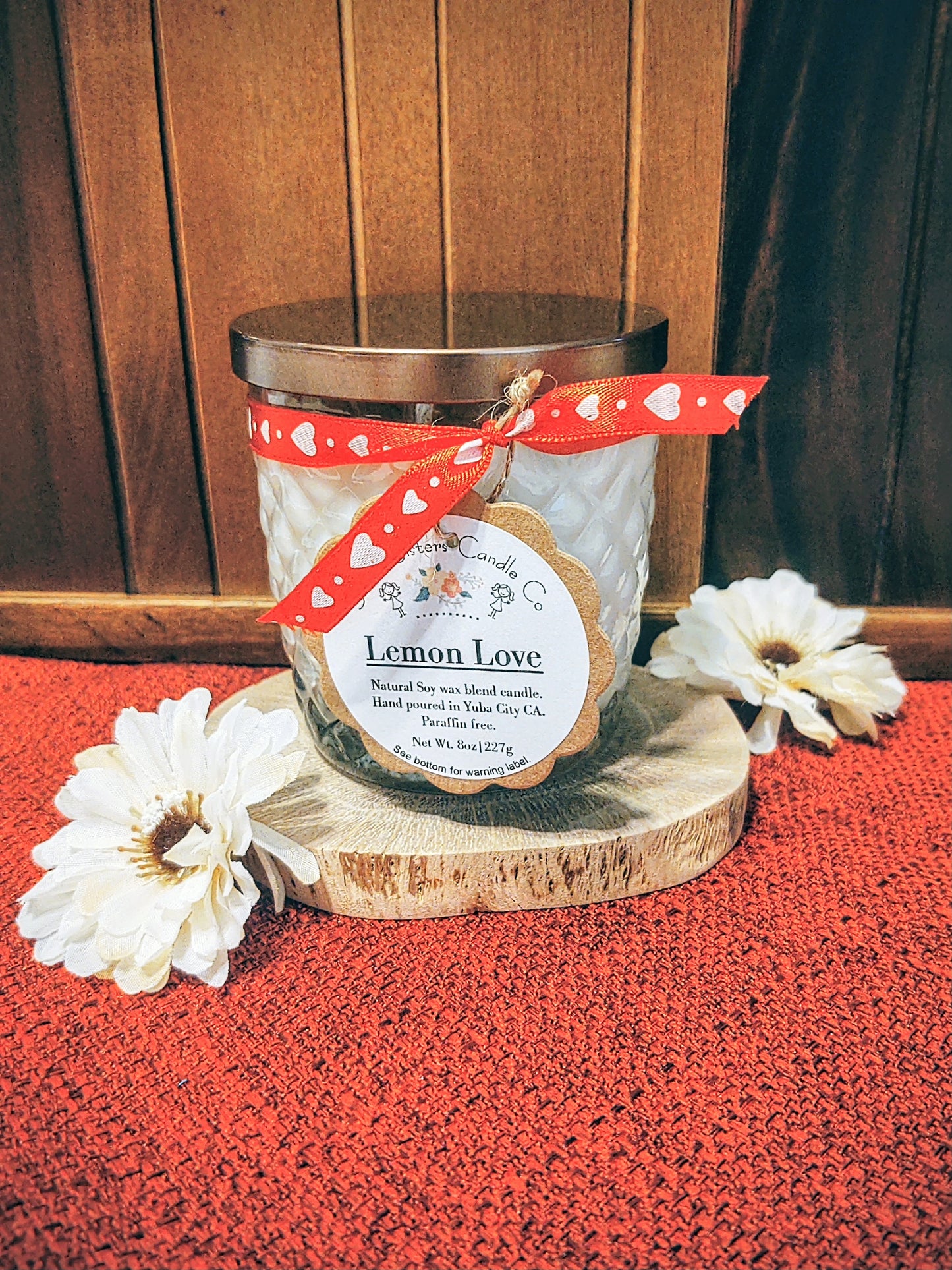 A decorative glass 8oz natural soy wax scented candle with a bronze metal lid. Double wicked with cleaner burning cotton wicks. Paraffin free, phthalate free fragrance infused with essential oils, lemon cake and vanilla scent.