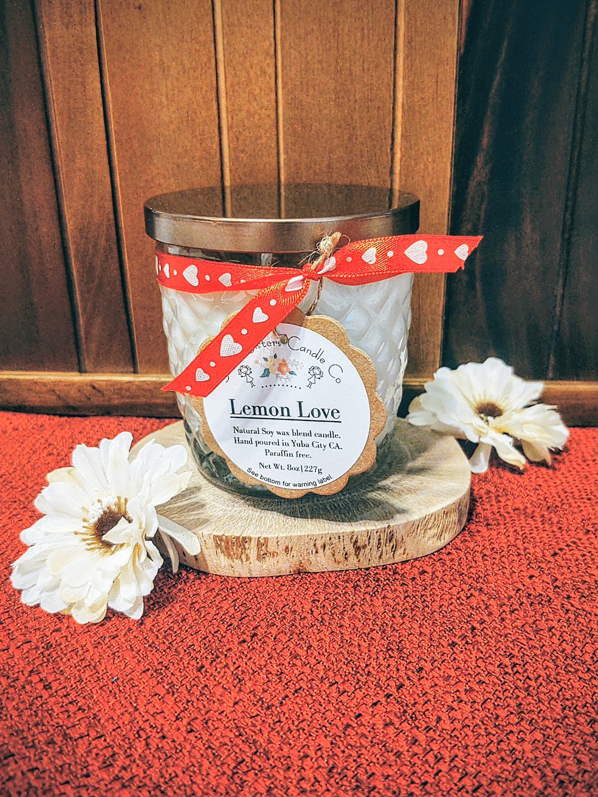 A decorative glass 8oz natural soy wax scented candle with a bronze metal lid. Double wicked with cleaner burning cotton wicks. Paraffin free, phthalate free fragrance infused with essential oils, lemon cake and vanilla scent.